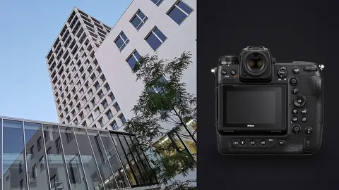 Nikon Z9 product photo beside modern glass office towers against blue sky