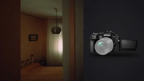 OM System OM-1 Mark II product photo beside empty bedroom with pendant lamp and sheer curtain