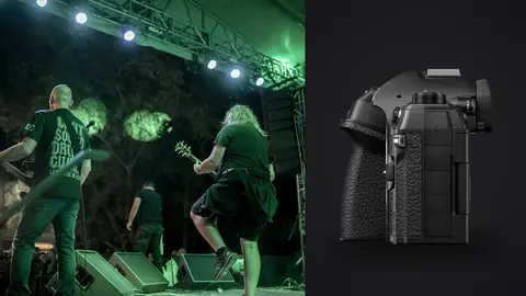 OM System OM-1 Mark II product photo beside musicians performing energetically on stage