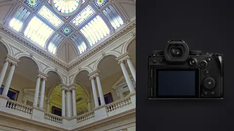 Panasonic Lumix S5IIX product photo beside grand stained glass domed atrium with columns