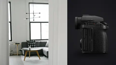Panasonic Lumix S5IIX product photo beside minimalist grey living room seen through open doorway