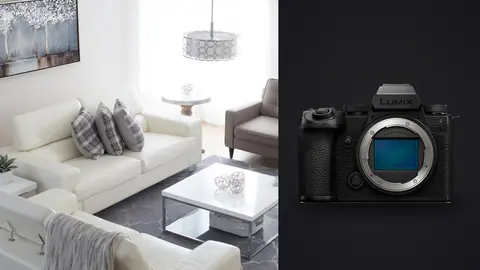 Panasonic Lumix S5IIX product photo beside modern living room with white sofas and grey armchair