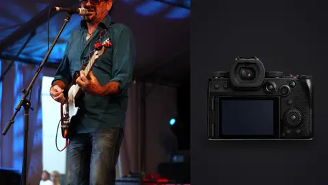 Panasonic Lumix S5IIX product photo beside guitarist singing on stage