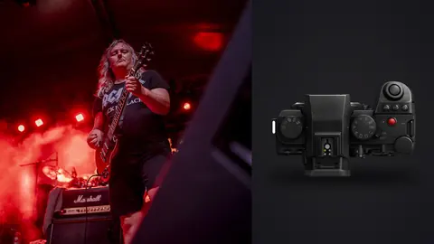 Panasonic Lumix S5IIX product photo beside guitarist performing on stage under red lights