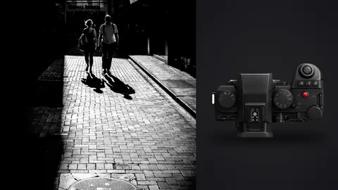 Panasonic Lumix S5IIX product photo beside couple walking hand in hand through a dramatic lit alley