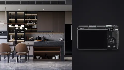 Ricoh GR IIIx product photo beside dark kitchen with marble island and pendant lighting