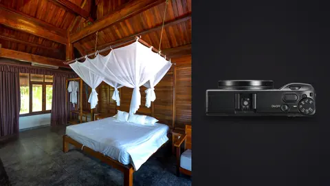 Ricoh GR IIIx product photo beside wood cabin bedroom with canopy netting over bed