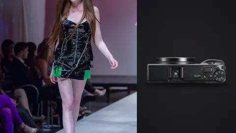 Ricoh GR IIIx product photo beside model in a black dress with green accents on a runway