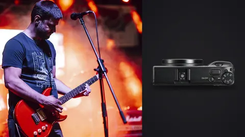 Ricoh GR IIIx product photo beside guitarist performing on stage under orange lights
