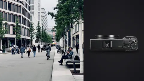 Ricoh GR IIIx product photo beside pedestrians walking along a tree lined city street