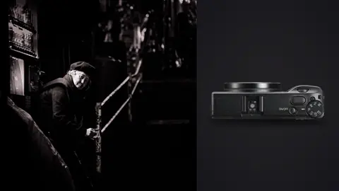 Ricoh GR IIIx product photo beside musician playing a stringed instrument in a dim alcove