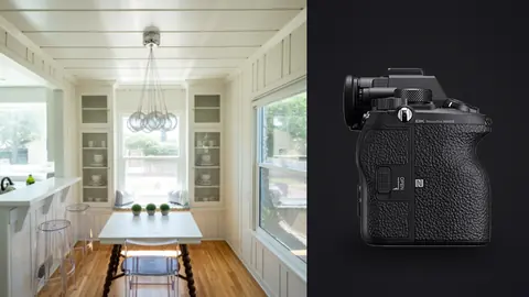 Sony Alpha 1 product photo beside bright farmhouse kitchen nook with dining table and glass cabinets