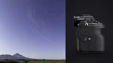 Sony Alpha 1 product photo beside moonlit star trails swirling above a volcanic peak