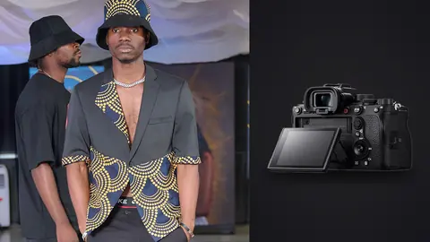 Sony Alpha 1 product photo beside two men in matching gold-patterned blazers and hats