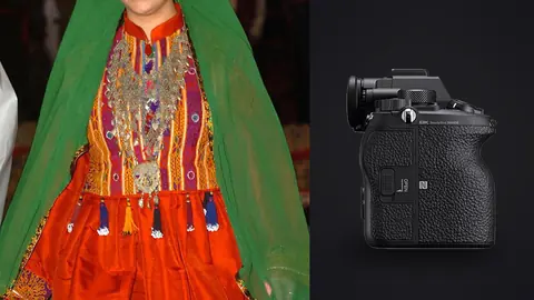 Sony Alpha 1 product photo beside model walks a runway in a traditional embroidered red and green dress