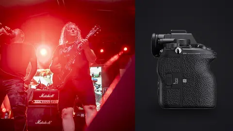 Sony Alpha 1 product photo beside musicians performing on stage under red lights