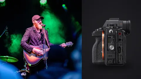 Sony Alpha 1 product photo beside guitarist singing on stage under green lights