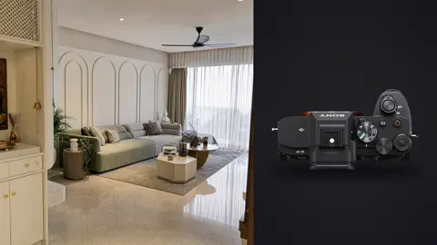 Sony a7 IV product photo beside modern living room with arched wall paneling and sage green sofa