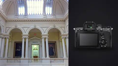 Sony a7 IV product photo beside grand courthouse hall with arched balcony and portraits