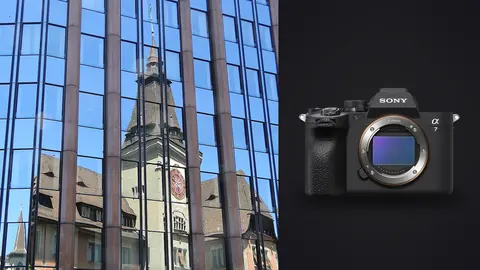 Sony a7 IV product photo beside historic clock tower reflected in modern glass facade