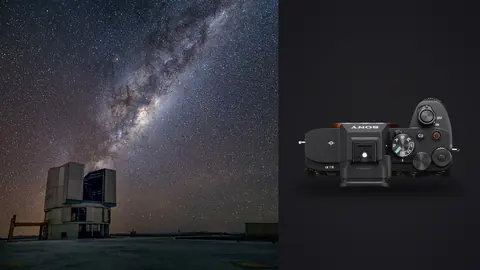 Sony a7 IV product photo beside milky way arcing beside a large observatory telescope building