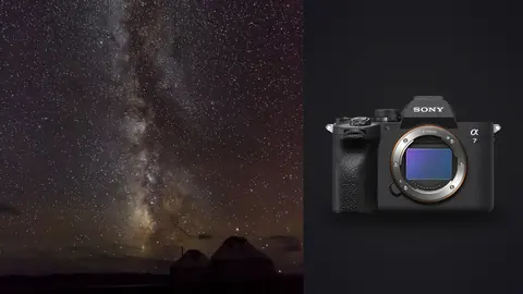 Sony a7 IV product photo beside milky way rising vertically above an observatory dome