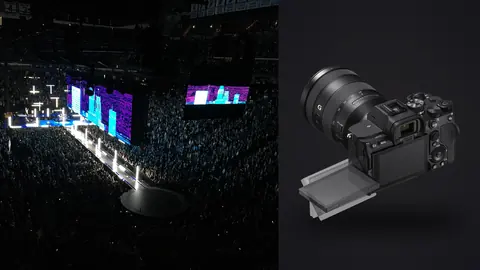 Sony a7 IV product photo beside large arena concert with crowd and screens