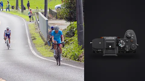Sony a7 IV product photo beside two cyclists leading a breakaway on a winding road