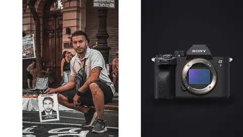 Sony a7 IV product photo beside man crouching beside a poster on a paved street