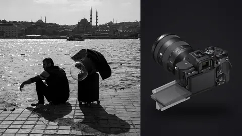 Sony a7 IV product photo beside two silhouetted figures sitting by the water at dusk