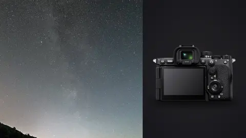 Sony a7R V product photo beside milky way over a silhouetted ridge above a calm inlet