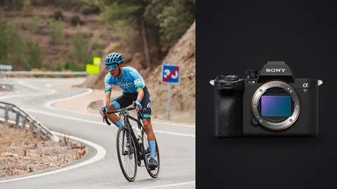 Sony a7R V product photo beside cyclist descending a winding mountain road at speed