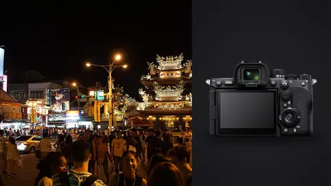 Sony a7R V product photo beside crowd gathered before a lit night market temple