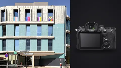 Sony a9 III product photo beside modern building facade with azure tiles and colorful pride flags