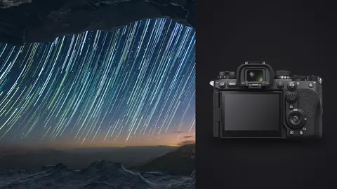 Sony a9 III product photo beside colorful star trail arcs framed by a rock overhang