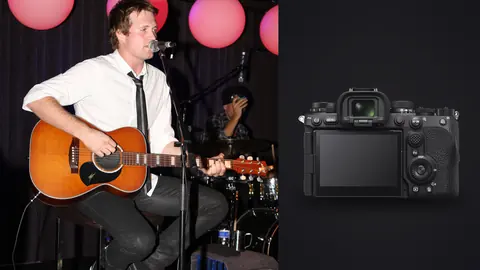 Sony a9 III product photo beside musicians performing seated on stage with lantern lights