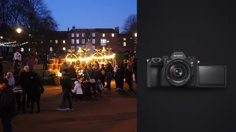 Sony a9 III product photo beside crowd gathered at an illuminated evening christmas market