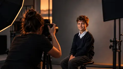 A real school photography session, a student being photographed against a studio backdrop